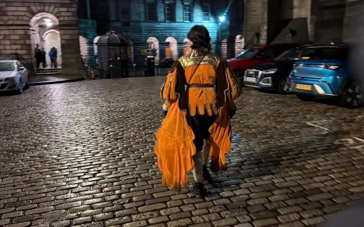 Wet cobbles and lamplight in an Edinburgh close at night