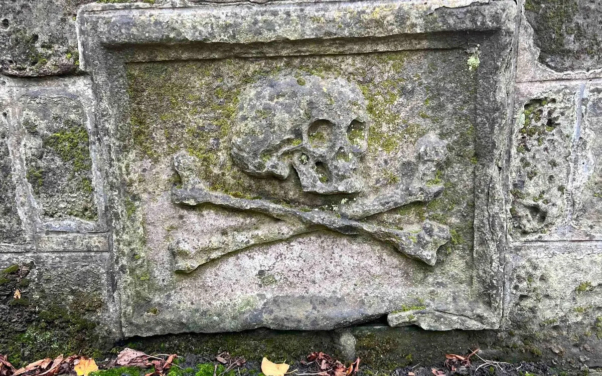 A weathered carved skull on an Edinburgh gravestone