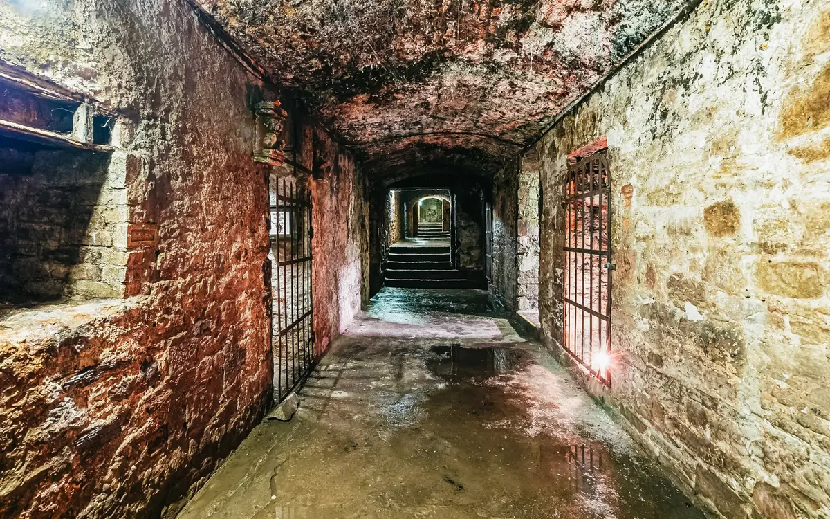 A lit stone corridor inside the Edinburgh underground vaults